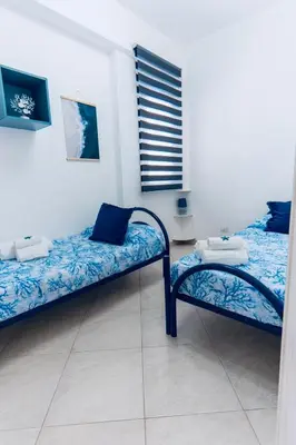 a room with two beds and a window at DV holiday home in Isola delle Femmine