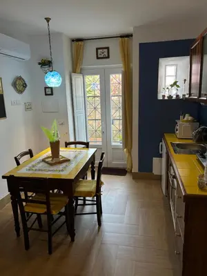 a kitchen with a table and chairs and a dining room at Le Calette Palermo in Palermo