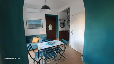 a dining room with a table and chairs in a room at Le Calette Palermo in Palermo