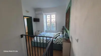 a small bedroom with a bed and a staircase at Le Calette Palermo in Palermo