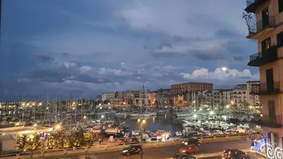 a view of a marina at night with cars at Le Calette Palermo in Palermo