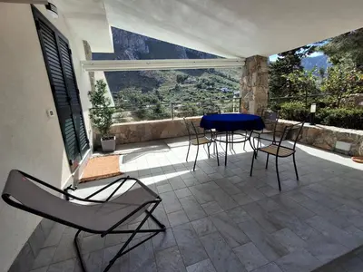 a patio with a table and chairs on a balcony at VFH Residence Flavia -Tre Piscine in Santa Flavia