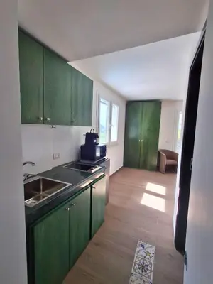 an empty kitchen with green cabinets and a sink at VFH Residence Flavia -Tre Piscine in Santa Flavia