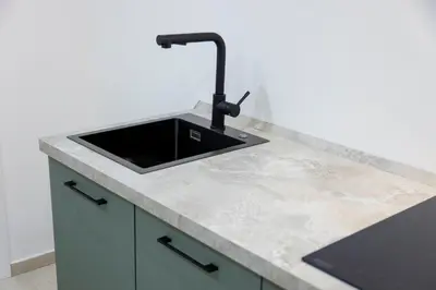 a kitchen with a sink and a counter top at Stratuzza Apartments in Palermo