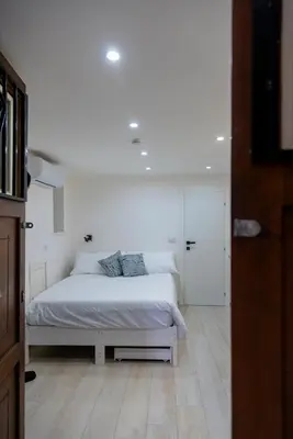 a bedroom with a white bed in a room at Stratuzza Apartments in Palermo