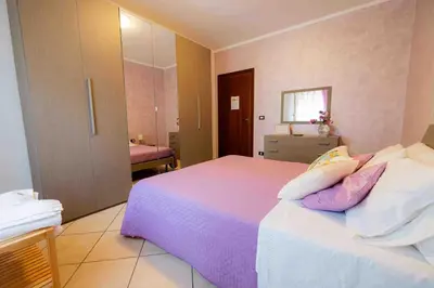 a bedroom with a large white bed with pillows at Liberia vacanze - A POCHI PASSI dal mare in Alcamo