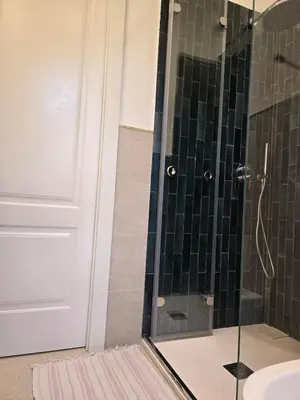 a bathroom with a shower with a glass door at Villa Lumos Mondello Beach in Palermo