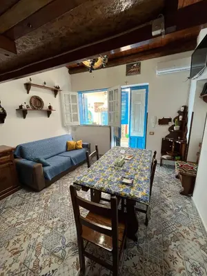 a living room with a table and a couch at Cortile Siciliano in Palermo