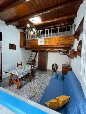 a living room with a blue couch and a table at Cortile Siciliano in Palermo