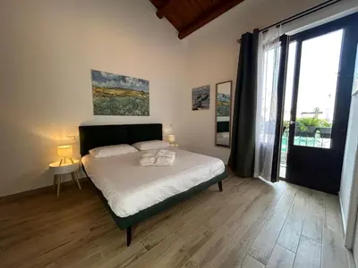 a bedroom with a bed and a large window at Tuppulia appartamenti in Palermo