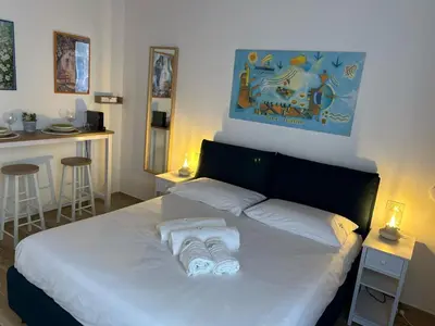 a bedroom with a bed with towels on it at Tuppulia appartamenti in Palermo