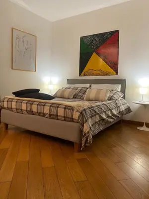 a bedroom with a bed and a painting on the wall at Cate Home historic center in Palermo