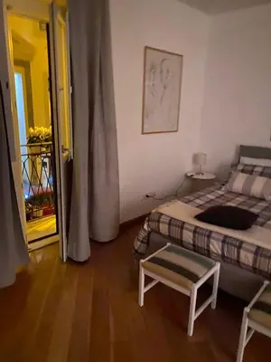 a bedroom with a bed and a table and a door at Cate Home historic center in Palermo