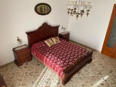 a bedroom with a bed and two night stands at La Dimora della Maestra in Vita