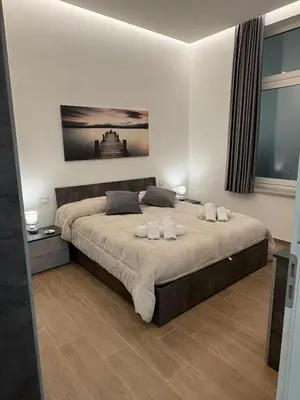a bedroom with a large bed with towels on it at Residenza Stabile 64 in Palermo