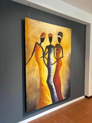 a painting of three women on a wall at Mondello Key loft in Palermo