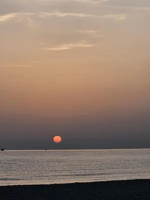 a sunset over the ocean with the sun in the sky at Mondello Key loft in Palermo
