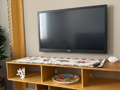 a flat screen tv sitting on top of a tv stand at Mondello Key loft in Palermo