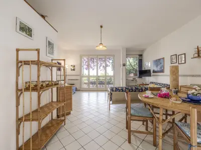 a living room with a table and a dining room at Apartment Cicladi Leros by Interhome in Santa Flavia
