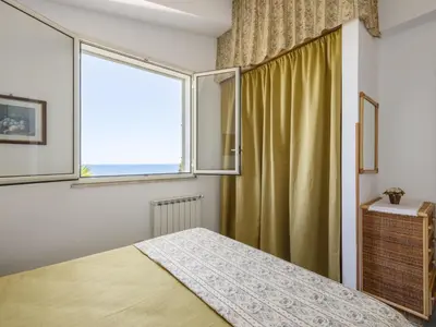 a bedroom with a bed and a large window at Apartment Cicladi Kea by Interhome in Santa Flavia