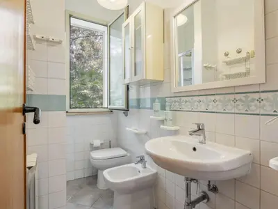 a white bathroom with a sink and a toilet at Apartment Cicladi Mikonos by Interhome in Santa Flavia