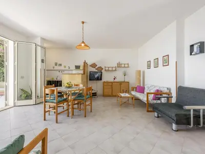 a living room with a table and chairs at Apartment Cicladi Mikonos by Interhome in Santa Flavia