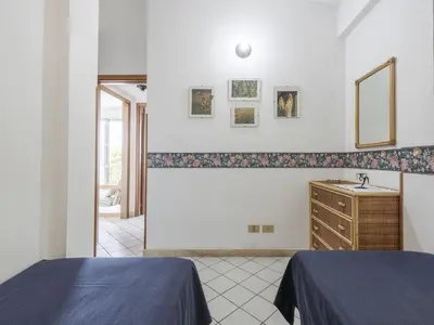 a bedroom with two beds and a sink and a mirror at Apartment Cicladi Paros by Interhome in Santa Flavia