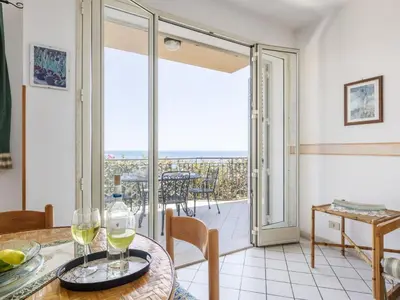 a dining room with a table with wine glasses on it at Apartment Cicladi Paros by Interhome in Santa Flavia
