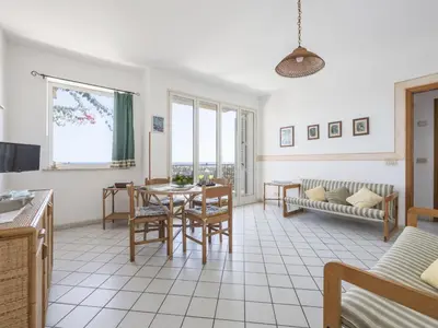 a kitchen and living room with a table and chairs at Apartment Cicladi Paros by Interhome in Santa Flavia