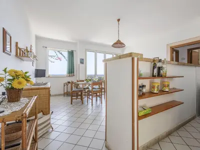 a kitchen with a refrigerator and a dining room at Apartment Cicladi Paros by Interhome in Santa Flavia
