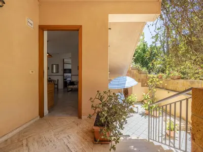 an open door to a balcony with potted plants at Apartment Cicladi Anafi by Interhome in Santa Flavia
