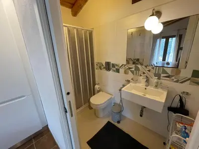 a bathroom with a toilet and a sink and a mirror at Lally in the Sky moderno monovano panoramico ed accessoriato in Scopello