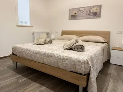 a bedroom with a large bed with pillows on it at Casa Francesca in Capaci