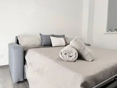 a bed with pillows and a blanket on it at Casa Francesca in Capaci