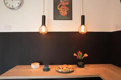 a table with a plate of food and lights at Courthouse Apartments Palermo in Palermo