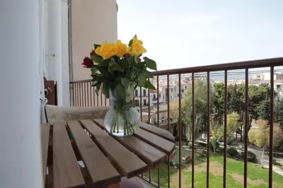 a vase of flowers sitting on a table on a balcony at Courthouse Apartments Palermo in Palermo