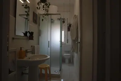 a bathroom with a sink and a toilet at Courthouse Apartments Palermo in Palermo