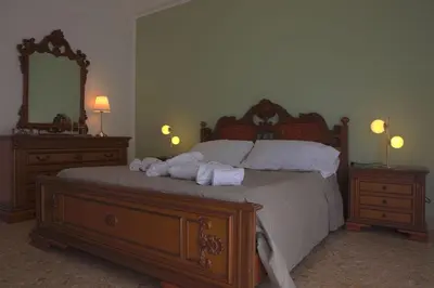a bedroom with a bed with towels on it at Courthouse Apartments Palermo in Palermo