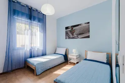 a bedroom with two beds and a window at Archi in Balestrate