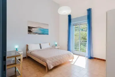 a bedroom with a bed and a large window at Archi in Balestrate