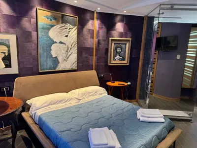 a bedroom with a bed and a glass shower at Amari 124 in Palermo