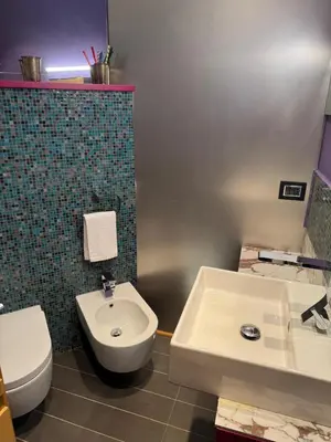 a bathroom with a toilet and a bidet and a sink at Amari 124 in Palermo