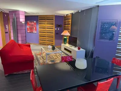 a living room with a red couch and a table at Amari 124 in Palermo