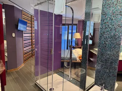 a glass shower in a room with a bedroom at Amari 124 in Palermo