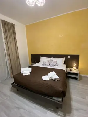 a bedroom with a large bed with towels on it at Palazzo Castelli alla Zisa in Palermo