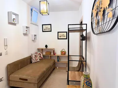 a living room with a couch and a shelf at Helena Apartments - Secondo Canto in Palermo