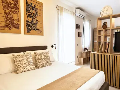 a bedroom with a white bed and a television at Helena Apartments - Secondo Canto in Palermo