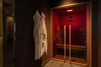 a robe hanging on a wall next to a window at Le Dimore - Ponte 7 in Palermo