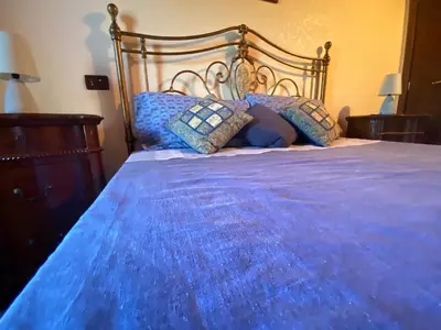 a blue bed with pillows on top of it at Villa Sunset in Campofelice di Roccella