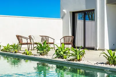 a patio with chairs and a swimming pool at Villa Castello in Balestrate